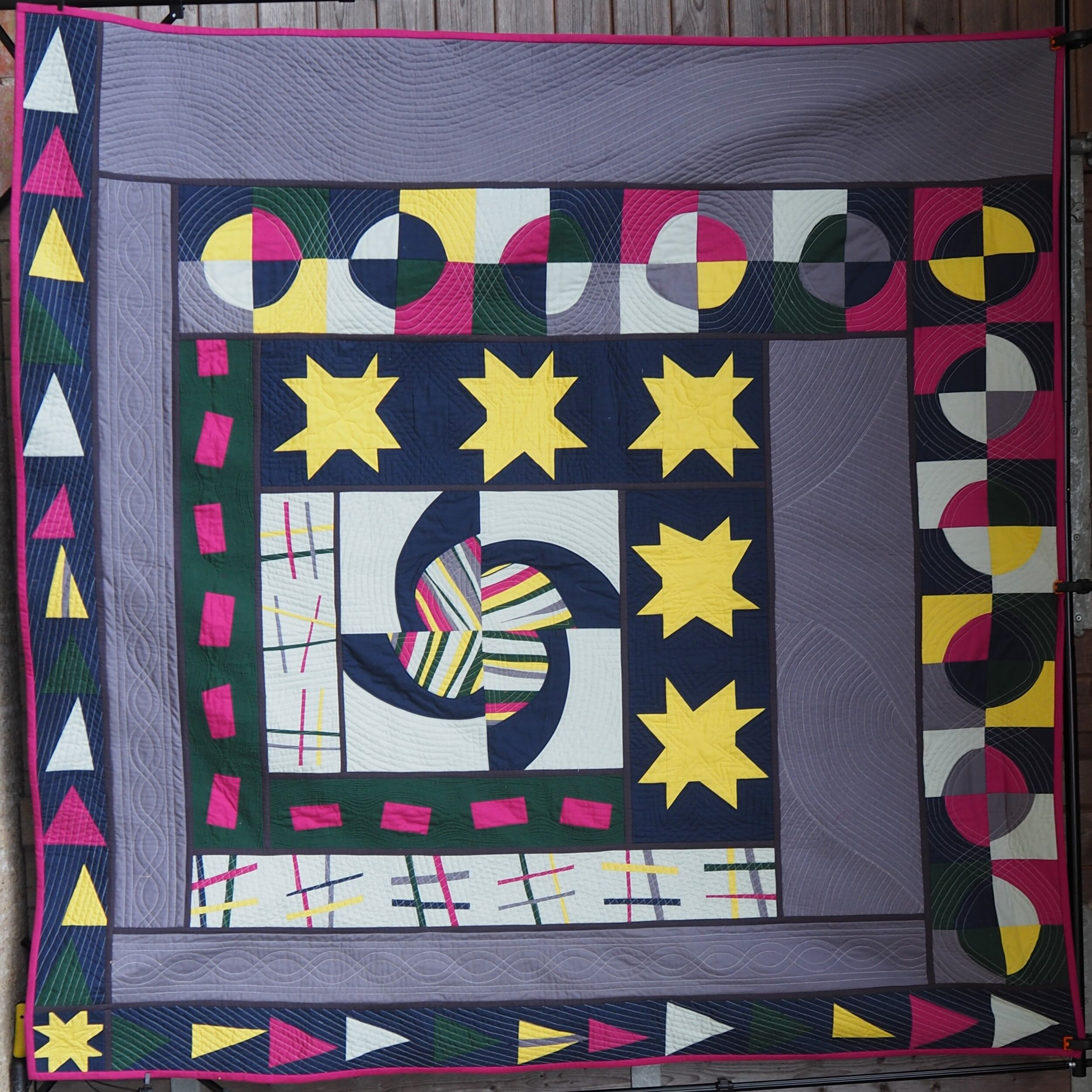 multi coloured quilt with lots of different walking foot quilting